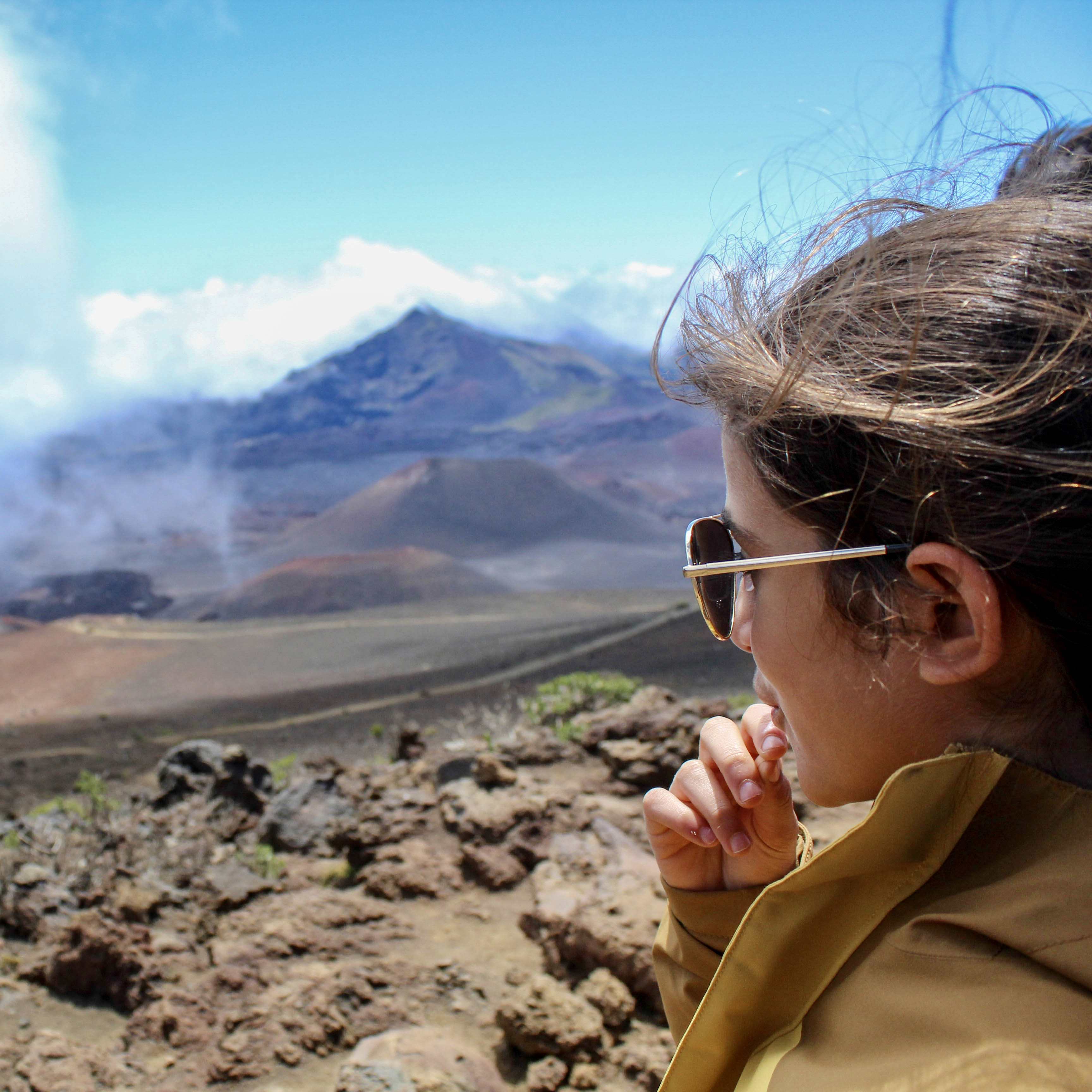 Image of a girl with a rock valley behind her.