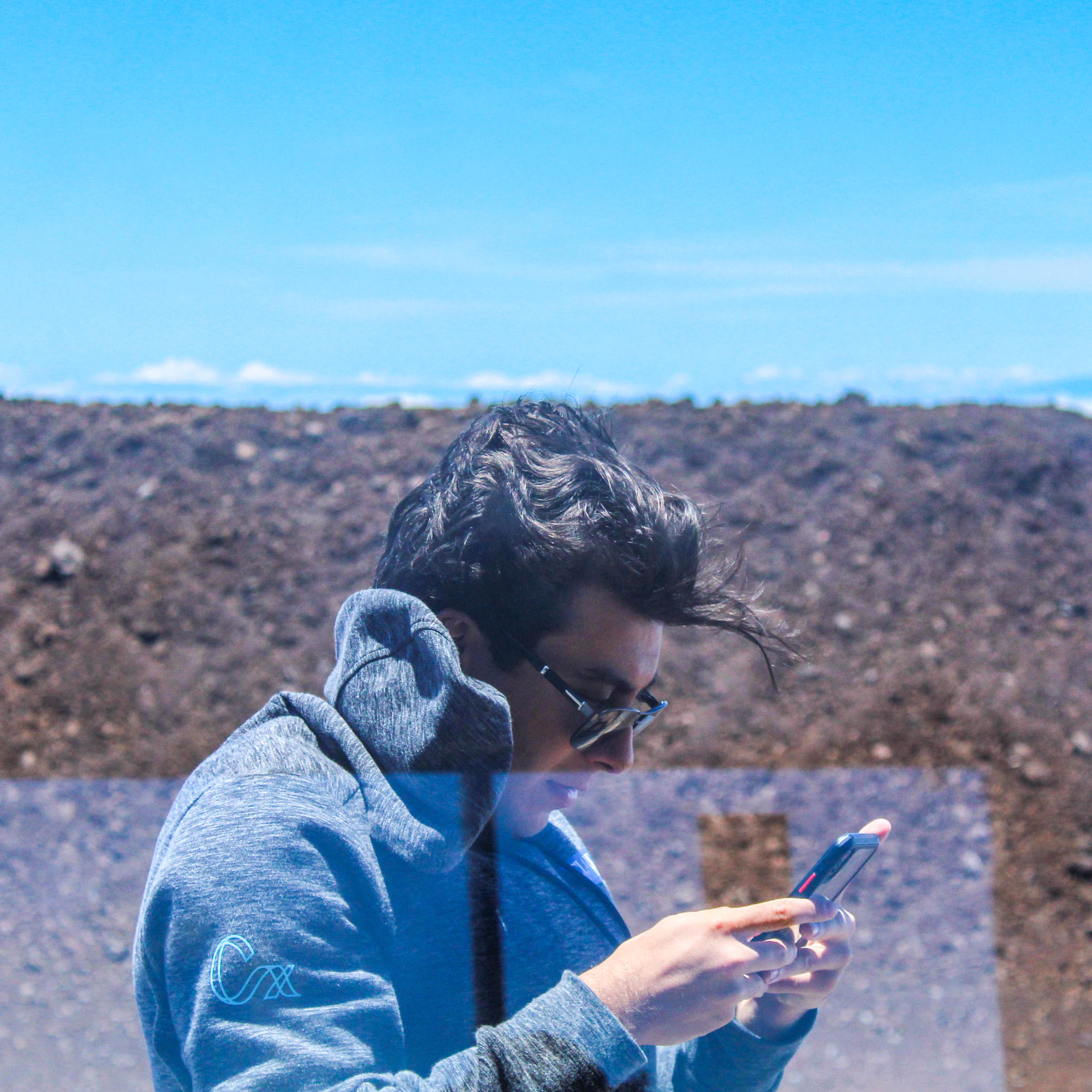 Image of a man checking his phone.
