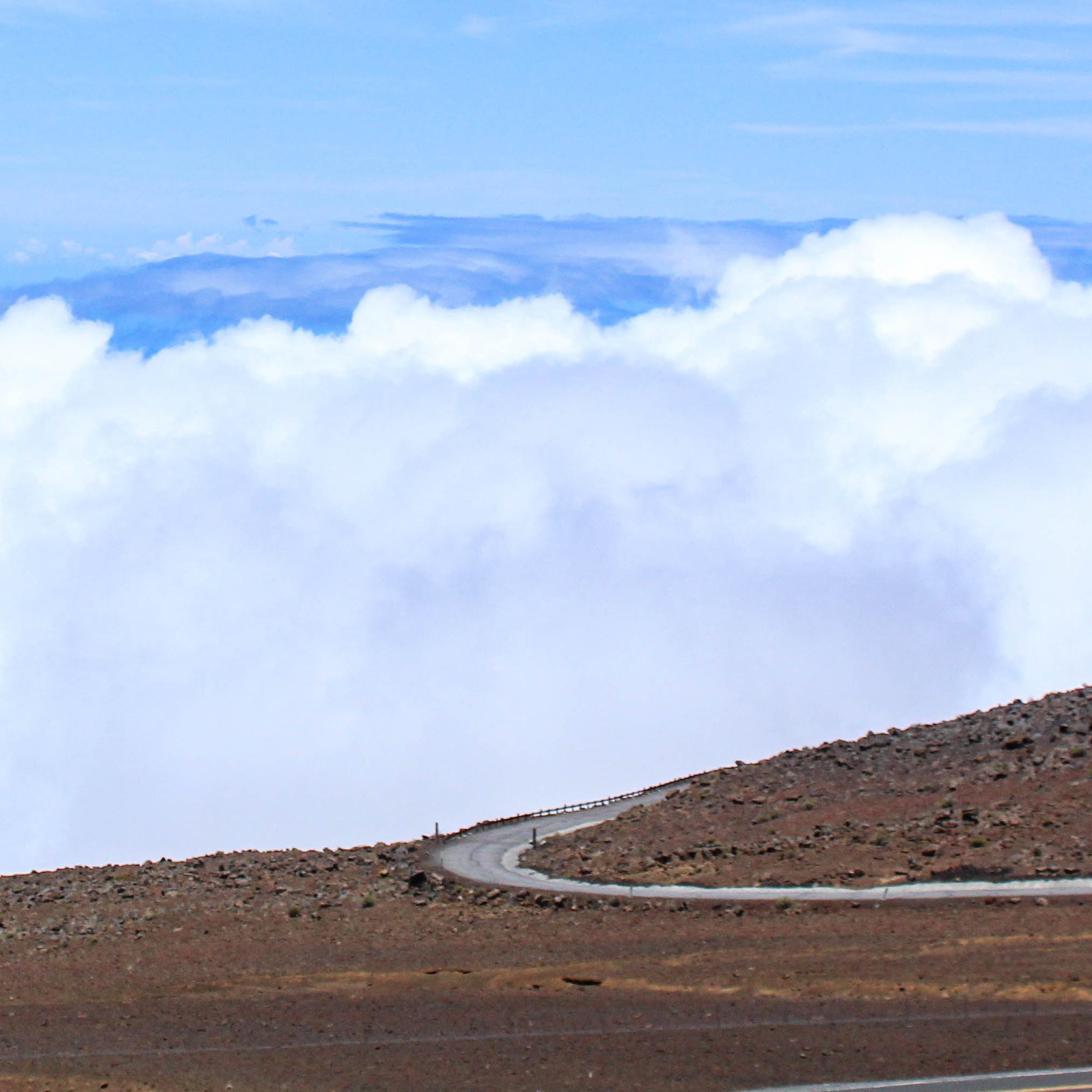 Image of a winding road above the clouds.
