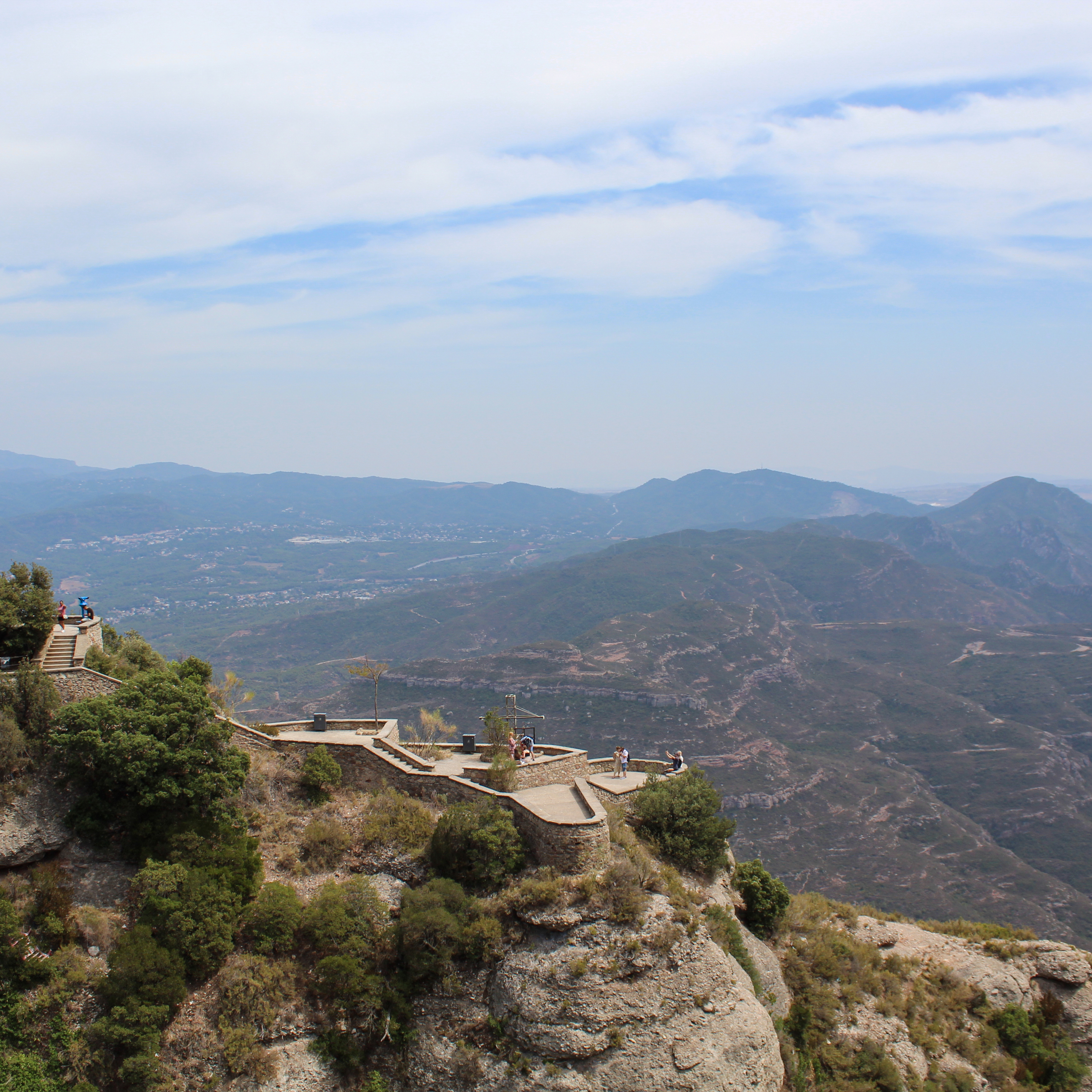 Image of rock paths and trees in the distance.